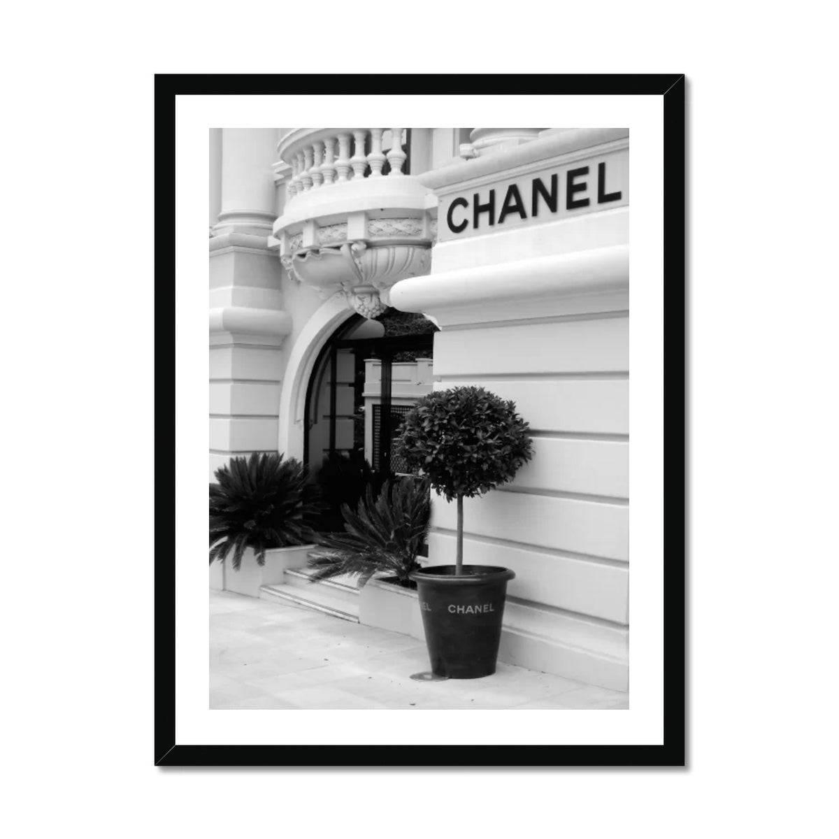 Chanel poster and adverts on the wall outside Maison Assouline
